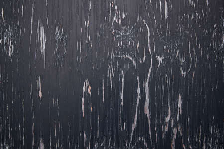 background consisting of wood with pattern of black peeling paintの写真素材