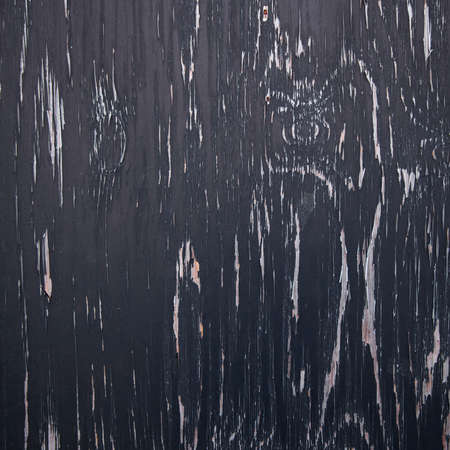 background consisting of wood with pattern of black peeling paintの写真素材