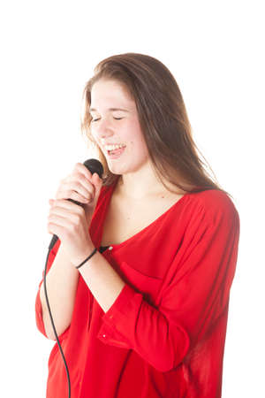 young brunette with microphone in studio against white backgroundの写真素材