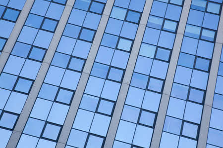 abstract pattern of blue squares on facade of office building
