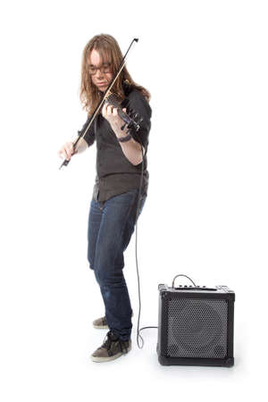 young man with glasses plays electric violin standing in studio against white backgroundの写真素材