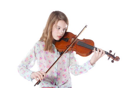 young girl in studio against white background plays the violinの写真素材