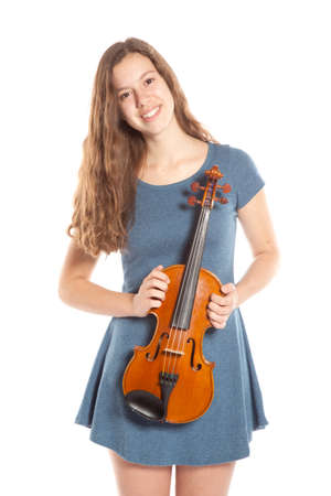 teenage girl in minidress stands with violin in studioの写真素材