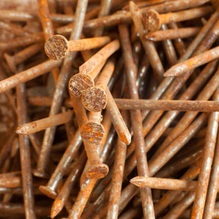 closeup of pile of old and rusty nailsの写真素材