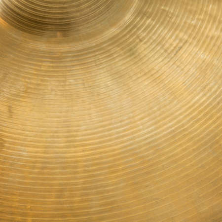 closeup of gold colored cymbal on square pictureの写真素材