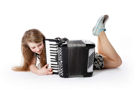 teenage girl on the floor of studio with accordion against white backgroundの写真素材