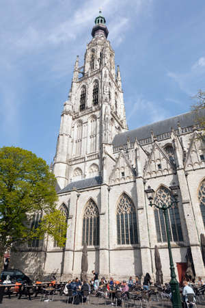 people enjoy the spring sun near breda cathedral in the netherlandsのeditorial素材