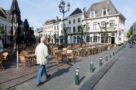 man walks on havermarkt in Breda on spring morning in the netherlandsのeditorial素材