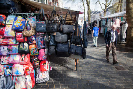bags hang from market stall in the dutch city of breda on sunny spring dayのeditorial素材