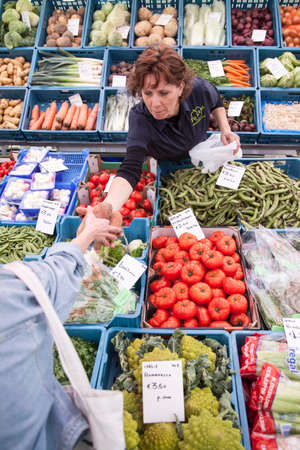 customer for fruit and vegetables on market in the dutch city of Bredaのeditorial素材