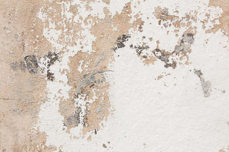 abstract pattern of broken stucco and paint on wallの写真素材