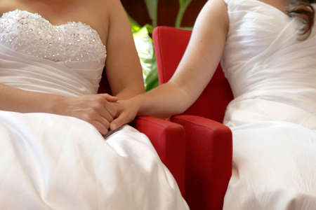 two brides on the verge of getting married hold handsの写真素材