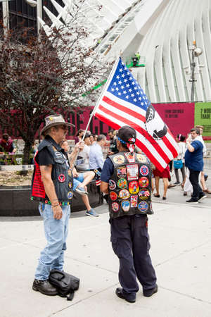 two patriots near ground zero with flag in new york city demonstrate in remembrance of 9-11のeditorial素材