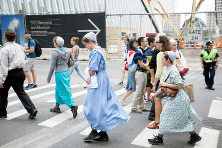 mennonite girls in traditionel dress cross the street in new york city near ground zeroのeditorial素材