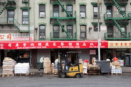 hard working people in front of shops on allen street in chinatown manhattan new york cityのeditorial素材