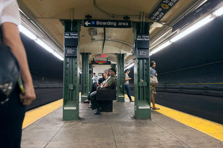 passengers wait on platform of subway station jay street metro tech in new york cityのeditorial素材