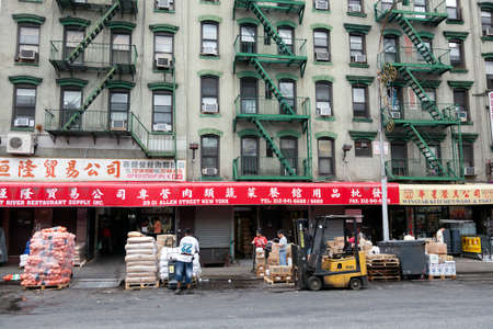 hard working people in front of shops on allen street in chinatown manhattan new york cityのeditorial素材