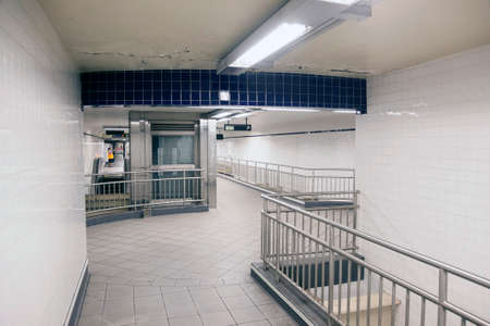 steel and white tiles in empty corridors of subway station new york cityの写真素材