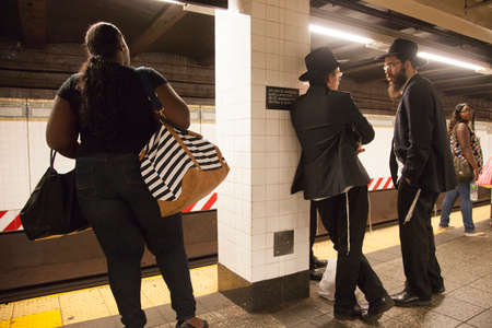 new york city, 11 september 2015: orthodox jes and african american passengers wait on platform of subway station atlantic avenue barclays ctr in new york cityのeditorial素材