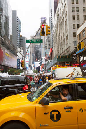 new york city, 12 september 2015: yellow cab and many people near market on west 50 street in new...