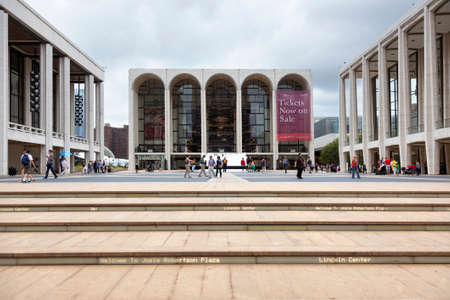 new york city, 12 september 2015: people walk on square in front of metropolitan opera house at...