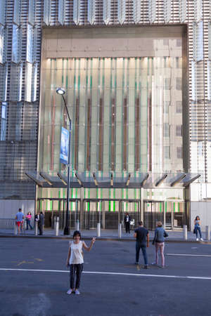 asian tourist poses in front of entrance one world trade center in lower manhattan new yorkのeditorial素材