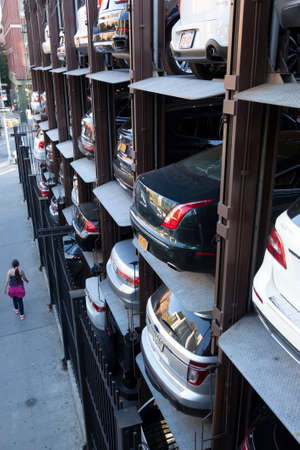 New York City, usa, 15 september 2015: girl near vertical car park in new york city seen from above