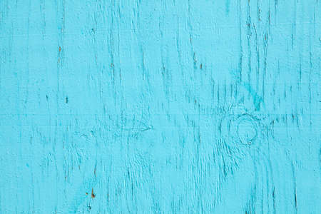 horizontal part of old  wood with fading cracked turqoise paintの写真素材