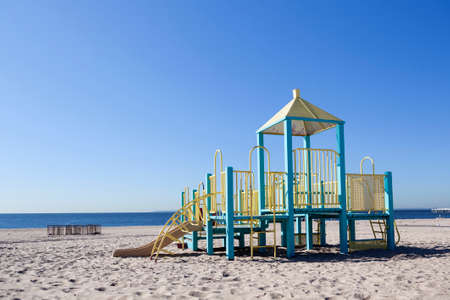 empty playground for children on beach of coney island on sunny september morningの写真素材