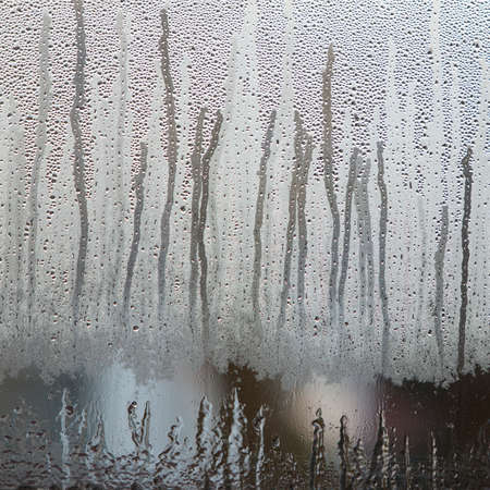 raindrops on dull misty glass of windowの写真素材