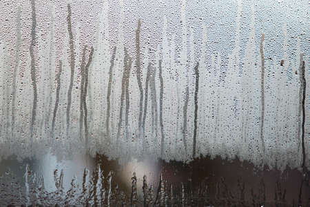 raindrops on dull misty glass of windowの写真素材