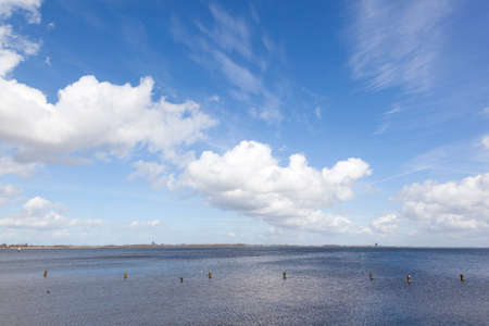 cloudscape above lake Gooimeer in the netherlands with Almere in the backgroundの写真素材