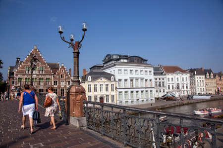 women walk on st michielsbrug in centre of medieval Ghent in Belgium on sunny summer dayのeditorial素材