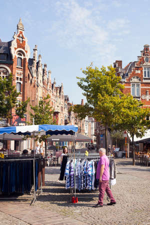 market stall and old houses near Vrijdagmarkt in medieval centre of Belgian town Ghentのeditorial素材