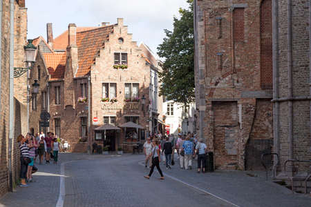 tourism in centre of old belgian city of bruges in flanders near old onze-lieve-vrouw churchのeditorial素材
