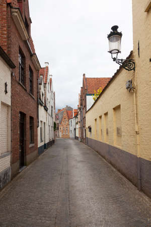 old empty cobblestone street in the belgian city of brugesの写真素材