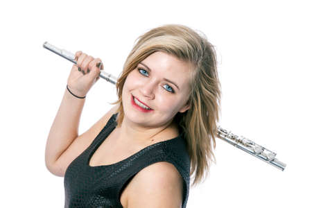 young blond caucasian woman and flute against white background in studioの写真素材