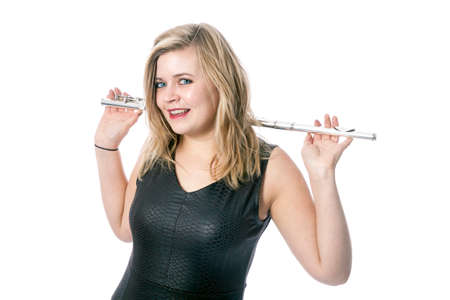 young blond caucasian woman and flute against white background in studioの写真素材