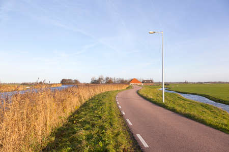oudelandsdijkje and farm in countryside north of amsterdam along canal near Purmer in noord-hollandの写真素材