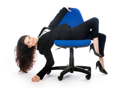 beautiful brunette secretary with sexy attitude on office chair in studio against white baqckgroundの写真素材