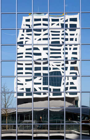 Utrecht, 15march 2017: new city office utrecht seen from footbridge reflected in glass building of rabobankのeditorial素材