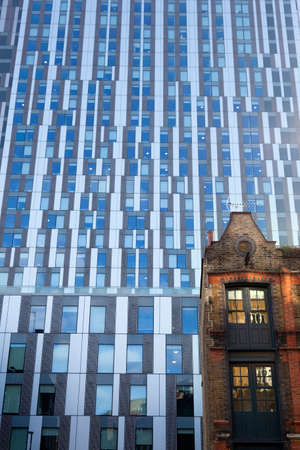 London, United Kingdom, 7 may 2017: very old warehouse with modern corporate building in the background in the city of londonのeditorial素材