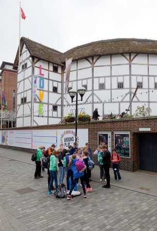 London, United Kingdom, 6 may 2017: group of teenagers stands in front of shakespeare's globe theatre on southbank of river thames in londonのeditorial素材