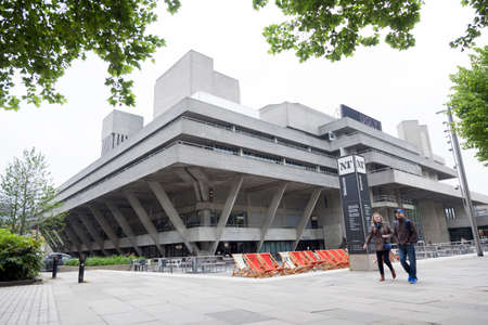 London, United Kingdom, 6 may 2017: couple walks on southbank of river thames in front of national theatre on overcast day in springのeditorial素材