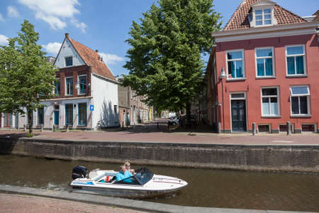 Leeuwarden, Netherlands, 11 june 2017: couple rides speed boat in leeuwarden canal on sunny summer dayのeditorial素材
