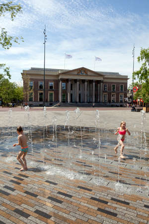 Leeuwarden, Netherlands, 11 june 2017: children play in fountain near court of justice in dutch town of leeuwarden in the netherlandsのeditorial素材