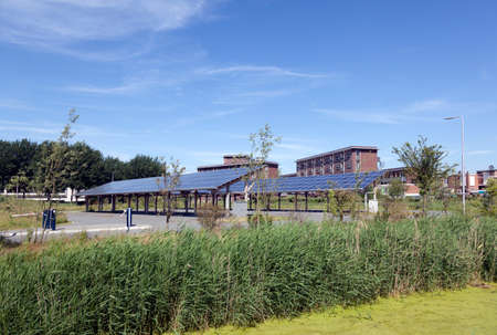 solar panels on roof of car parking at water campus leeuwarden in the  netherlands under blue skyの写真素材