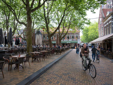 delft, netherlands, 30 june 2017: people on outdoor cafe in center of old dutch town delft in the netherlandsのeditorial素材