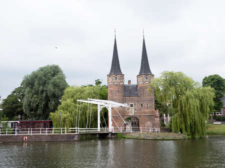 Delft, netherlands, 30 june 2017: woman and boy on bike at oostpoort in old dutch town of delftのeditorial素材