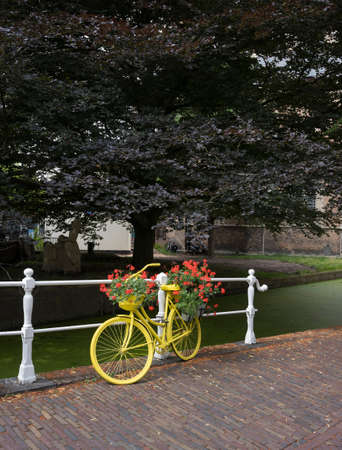 yellow bicycle with flowers.の写真素材